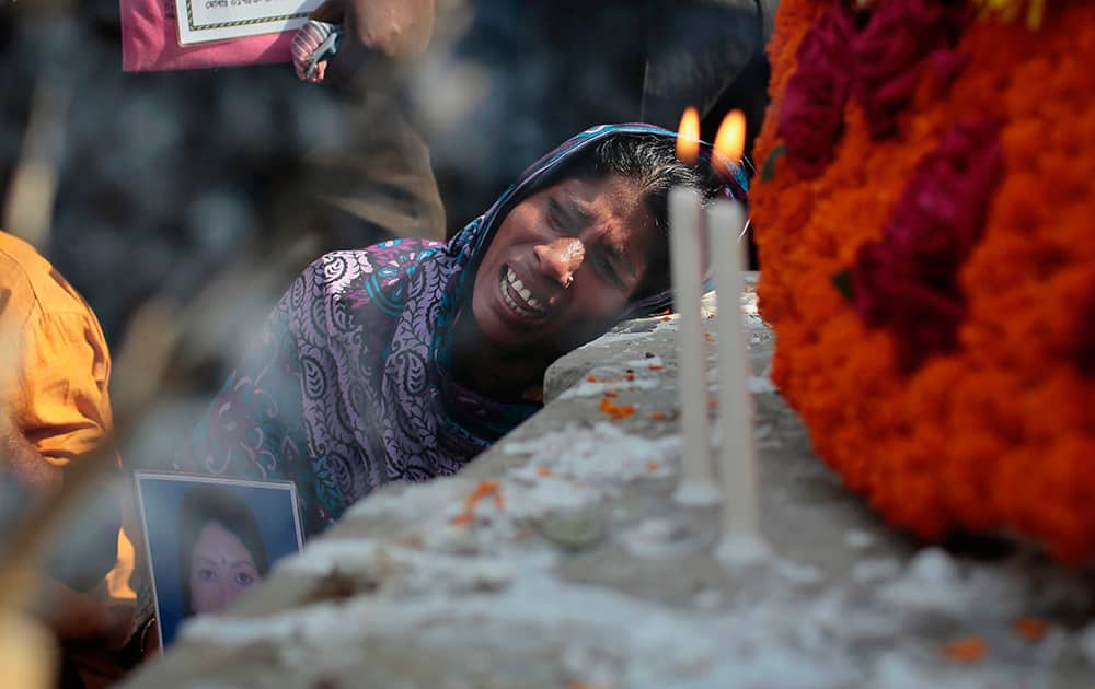 Bangladeshi relative of a victim cries in front of a monument erected in memory of the victims of Rana Plaza building collapse as they gather at the spot on its second anniversary in Savar, near Dhaka, Bangladesh.