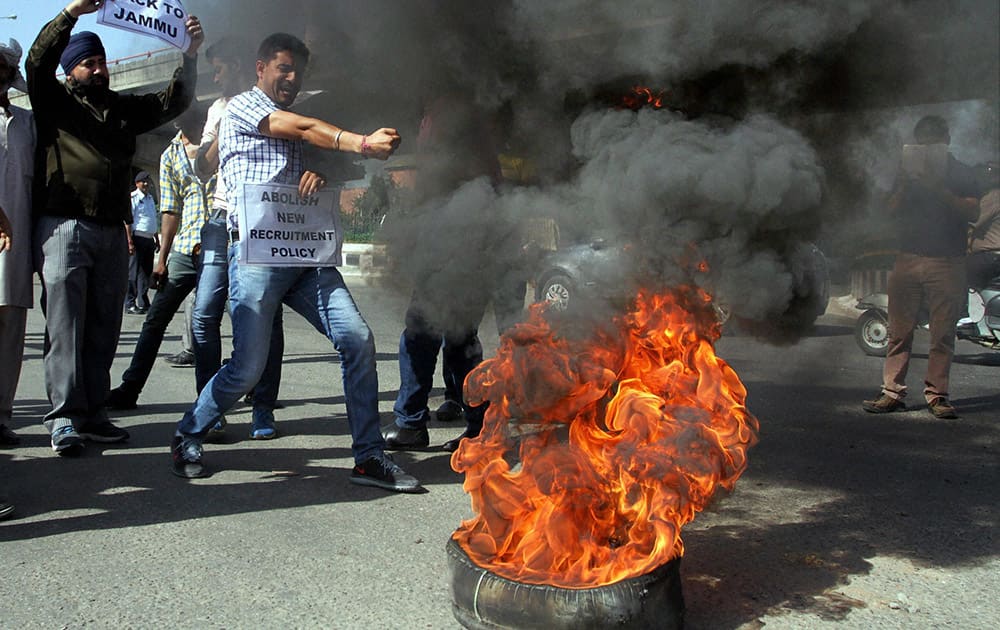 Panthers Party former MLA and workers burning tyres protesting against the government decision to give AIIMS to Kashmir which was originally offered to Jammu.