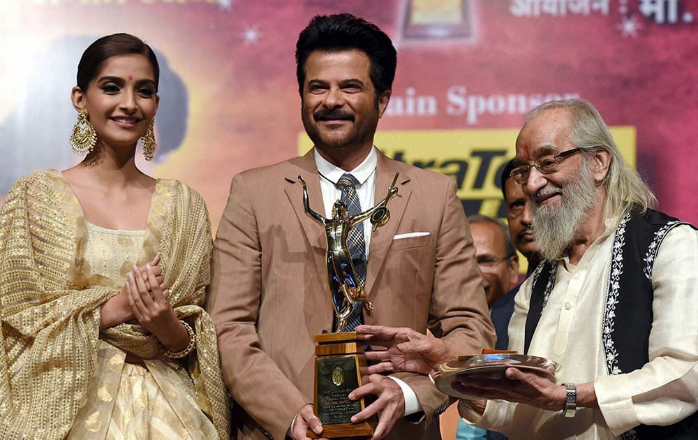 Actor Anil Kapoor receives the Dinanath Mangeshkar award from veteran historian Babasaheb Purandare in Mumbai on Friday. Actress Sonam Kapoor is also seen. 