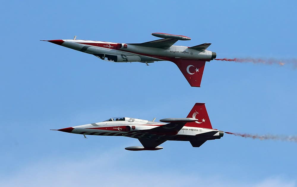 The Turkish army's aerobatic demonstration team, the Turkish Stars, perform with their supersonic jets during the Turkish International Service at Mehmetcik Abide in the Gallipoli Peninsula, Turkey.