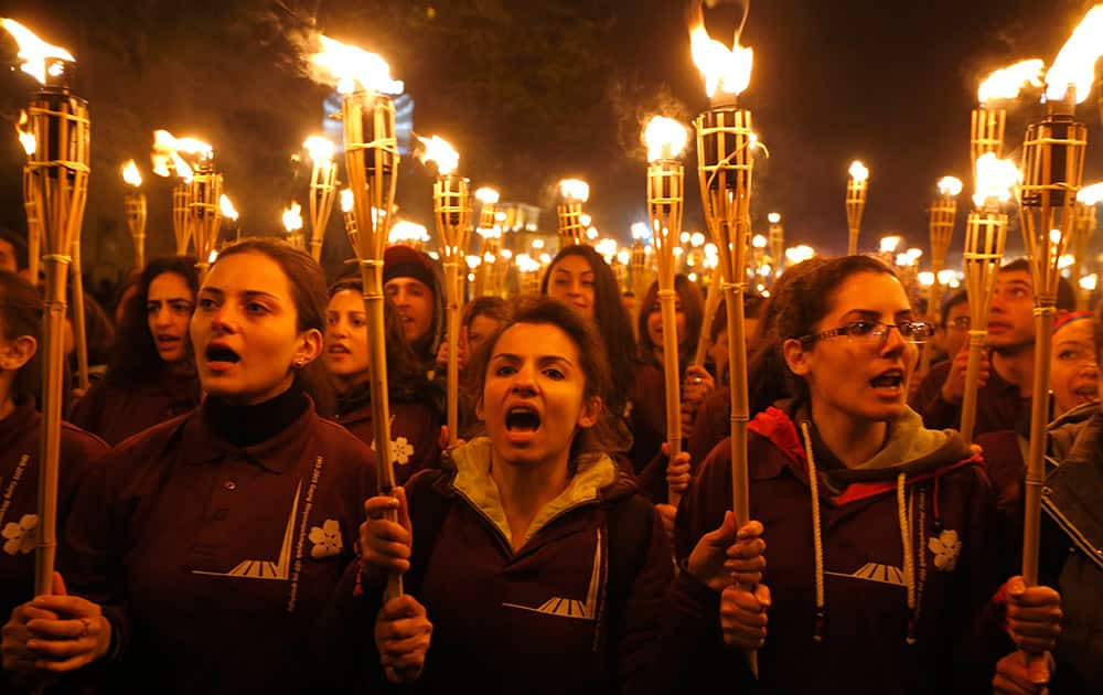 Armenians walk with torches to the monument to the victims of mass killings by Ottoman Turks, in Yerevan, Armenia.