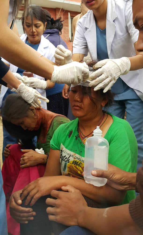 Injured people receive treatment in Kathmandu, Nepal. A strong magnitude-7.9 earthquake shook Nepal's capital and the densely populated Kathmandu Valley before noon Saturday, causing extensive damage with toppled walls and collapsed buildings, officials said.