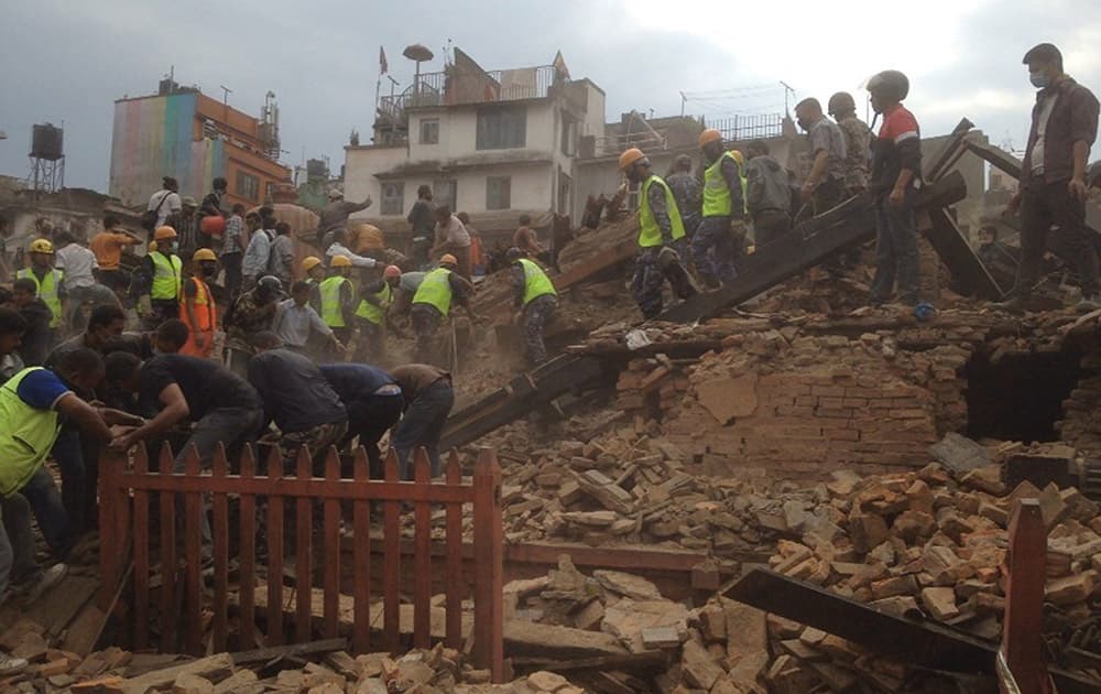 Rescuers clear the debris at Durbar Sqaure after an earthquake in Kathmandu, Nepal. A strong magnitude-7.9 earthquake shook Nepal's capital and the densely populated Kathmandu Valley before noon Saturday, causing extensive damage with toppled walls and collapsed buildings, officials said.