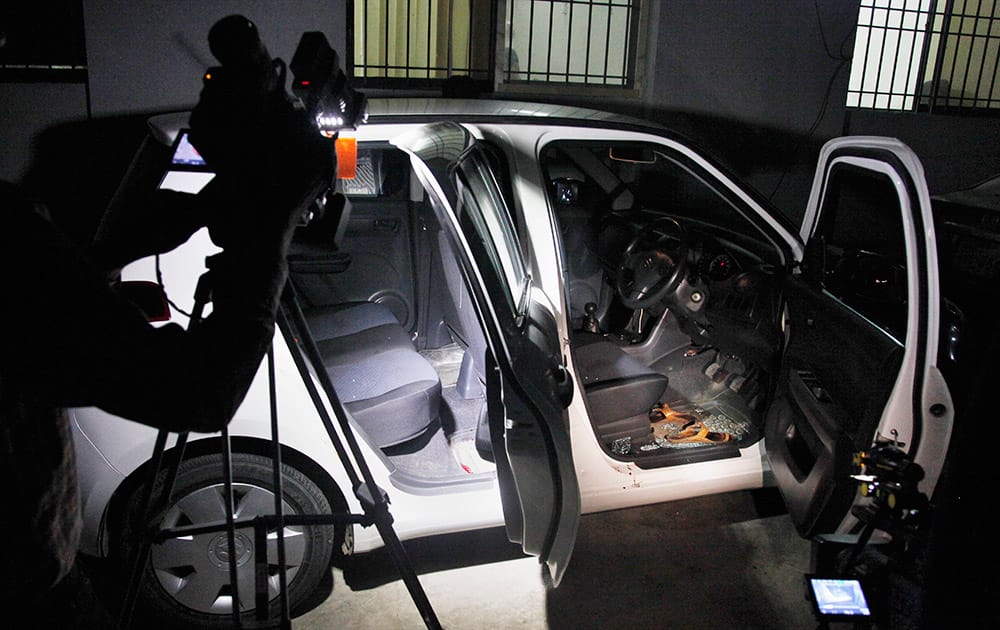 A Pakistani cameraman films the damaged car of a prominent women's rights activist Sabeen Mehmud following an attack on Mehmud in Karachi, Pakistan. Police in Pakistan say gunmen have killed the prominent women's rights activist in the hours after she held a forum about the country's restive Baluchistan region. 