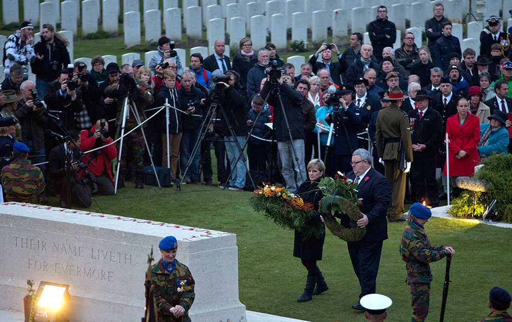 Australian Foreign Minister Julie Bishop, center left, lays a wreath on a monument during an ANZAC Day dawn service at Polygon Wood in Zonnebeke, Belgium.