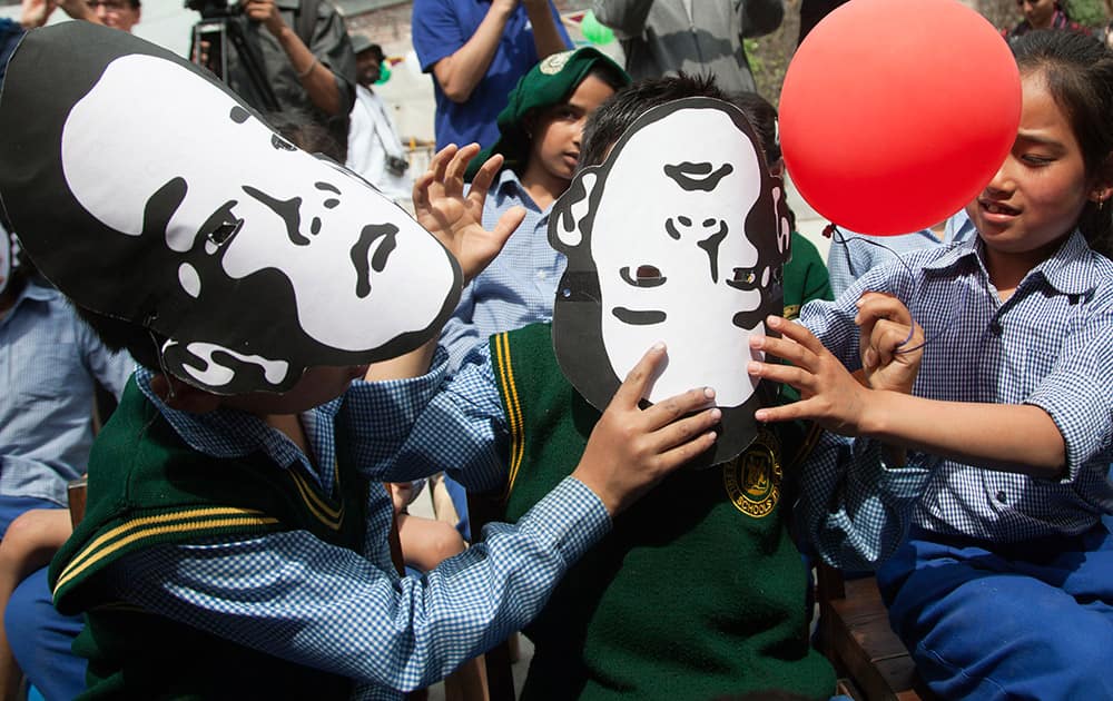 Exile Tibetan school children wear masks of Gedhun Choekyi Nyima, the Panchen Lama chosen by Dalai Lama, to mark his 26th birthday in Dharmsala. Panchen Lama, the second highest leader in Tibetan Buddhist hierarchy, who has not been seen since 1995.