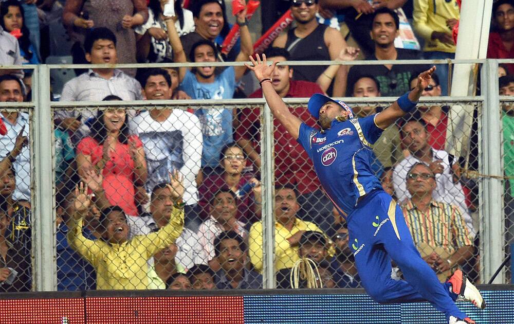 Mumbai Indians Vinay Kumar jumps to catch the ball during the IPL match against SRH in Mumbai.