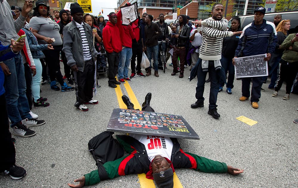 Demonstrators protest in the streets as they march for Freddie Gray to Baltimore's City Hall.