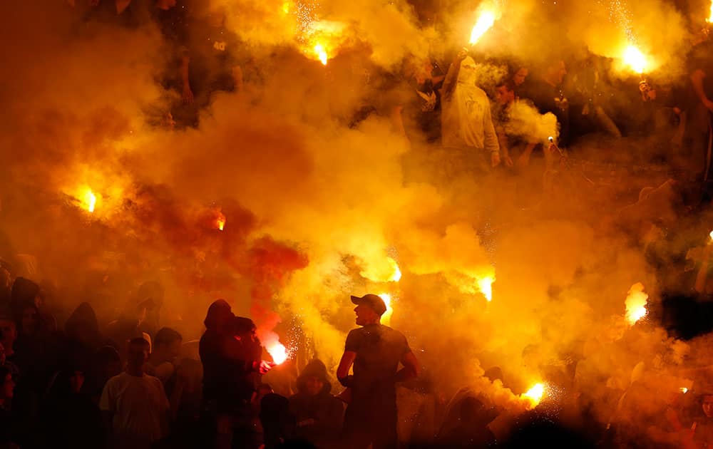 Partizan soccer fans light torches during a Serbian National soccer league derby match between Red Star and Partizan, in Belgrade, Serbia.