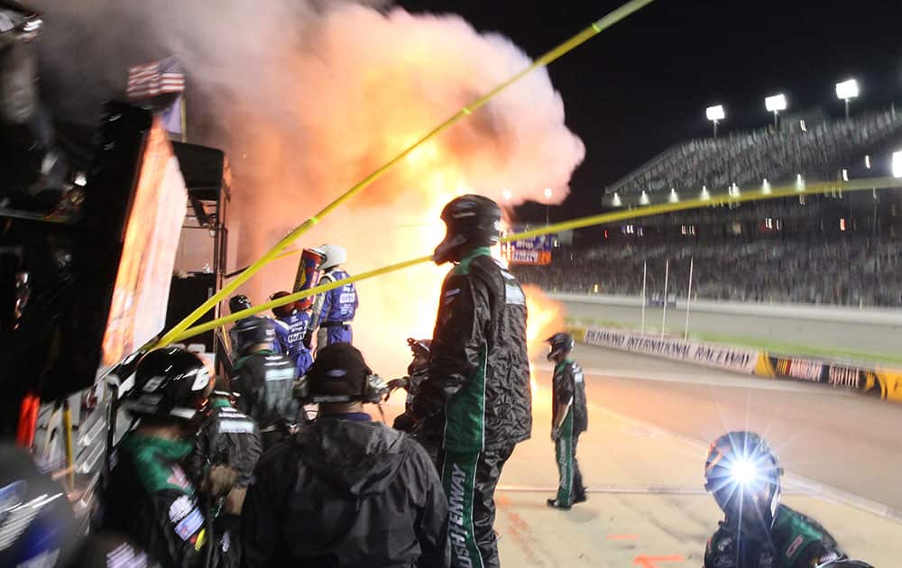 A fire burns on pit road during the the NASCAR Xfinity auto race at Richmond International Raceway in Richmond, Va.