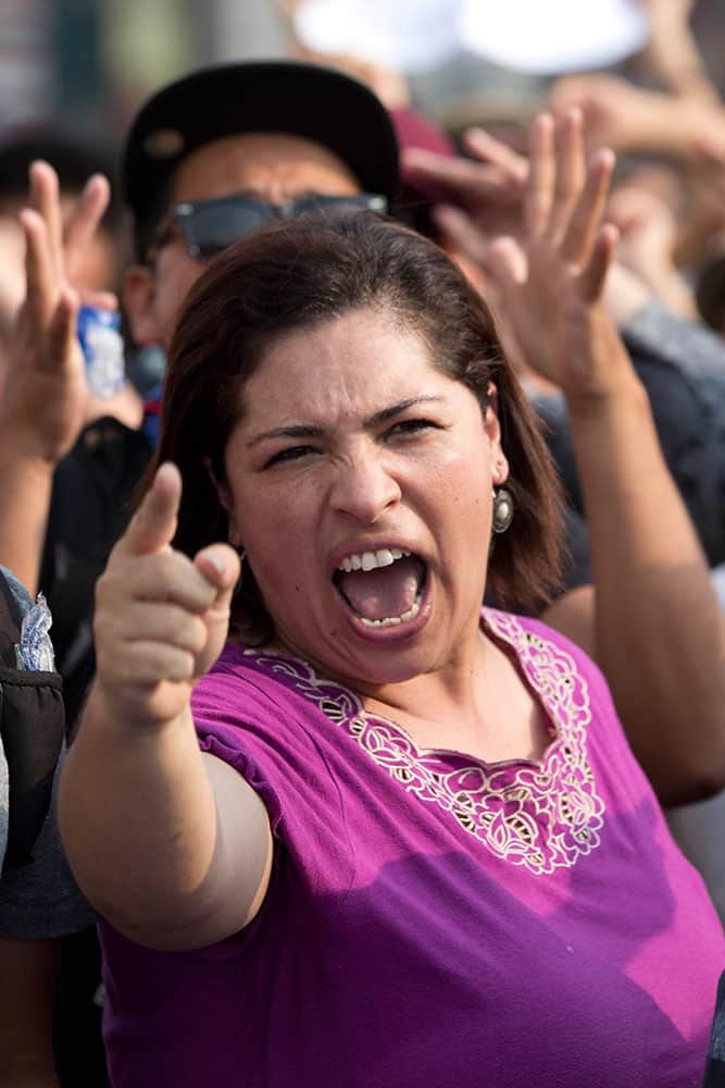 A woman chants slogans against Guatemalan President Otto Perez Molina during a protest sparked by a recent corruption scandal, in Guatemala City.