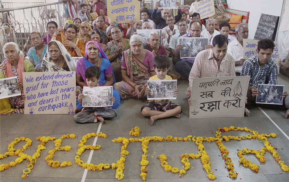 People pay tribute to victims of earthquake in Nepal inside a temple in Ahmedabad.

