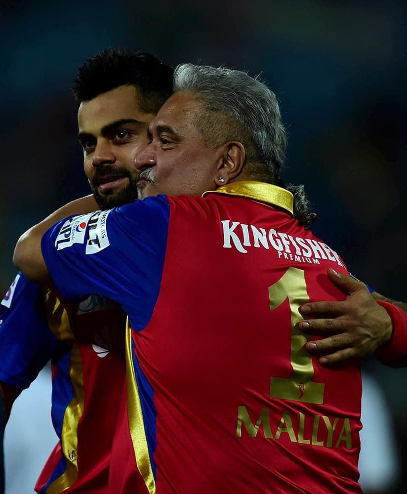 Royal Challengers Bangalores captain virat Kohli celebrate with team owner Vijay Mallya after win over Delhi Daredevils during an IPL match at Feroz Shah Kotla Stadium in New Delhi.