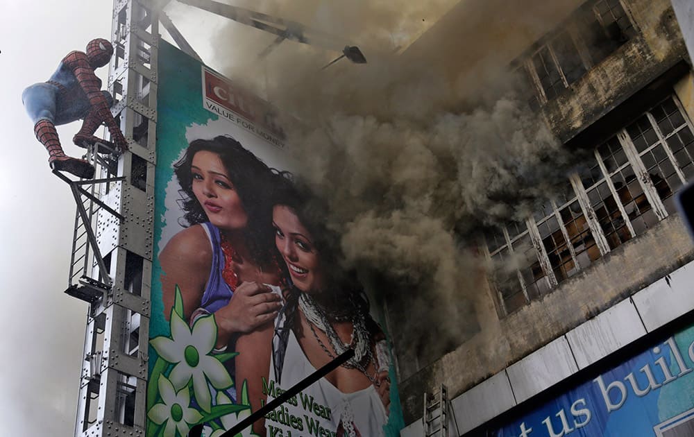 Smoke emits from a shopping mall building after a fire broke out in Kolkata, India.