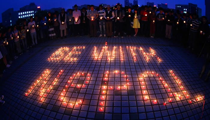 students light candles and pray for people trapped in Nepal earthquake at the University of South China in Hengyang City, central China's Hunan Province. Saturday's earthquake was the worst to hit the South Asian nation in more than 80 years. .