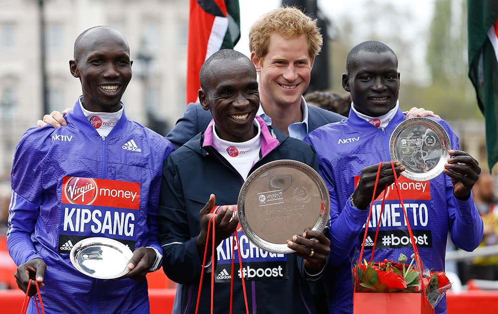 Britain's Prince Harry poses for a picture with winners of the Men's race Wilson Kipsang who came second, left, Eliud Kipchoge who came first, centre, and Dennis Kimetto who came third, right, at the 35th London Marathon.