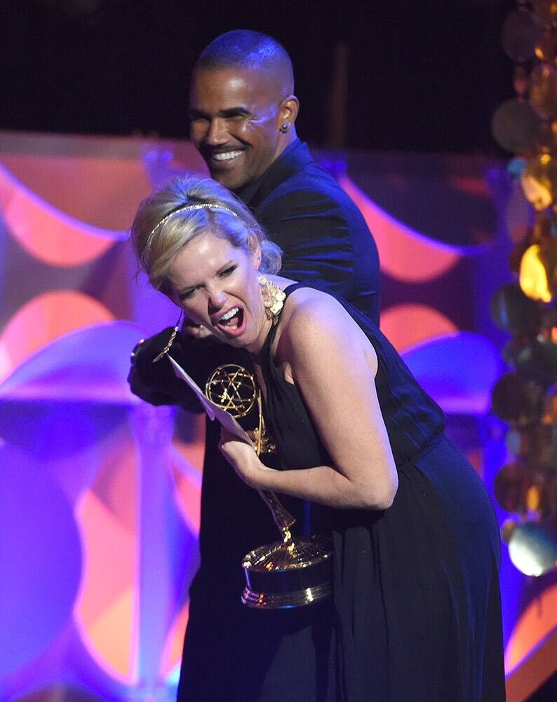 Shemar Moore, left, presents Maura West with the award for outstanding lead actress in a drama series at the 42nd annual Daytime Emmy Awards at Warner Bros. Studios.