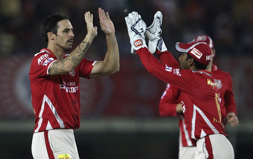 Mitchell Johnson of Kings XI Punjab and Wriddhiman Saha of Kings XI Punjab celebrate wicket of Ravi Bopara of Sunrisers Hyderabad during an IPL match in Mohali.