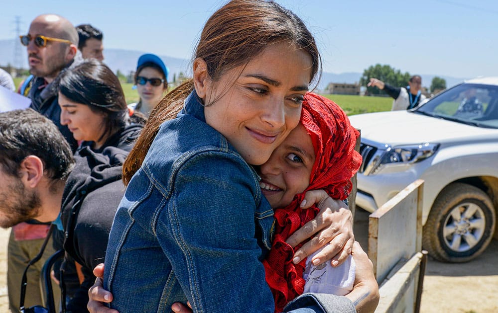 Mexican and American actress Salma Hayek hugs a Syrian refugee girl during her visit at Saadnayz UNICEF protection center in the Bekaa Valley, Lebanon.