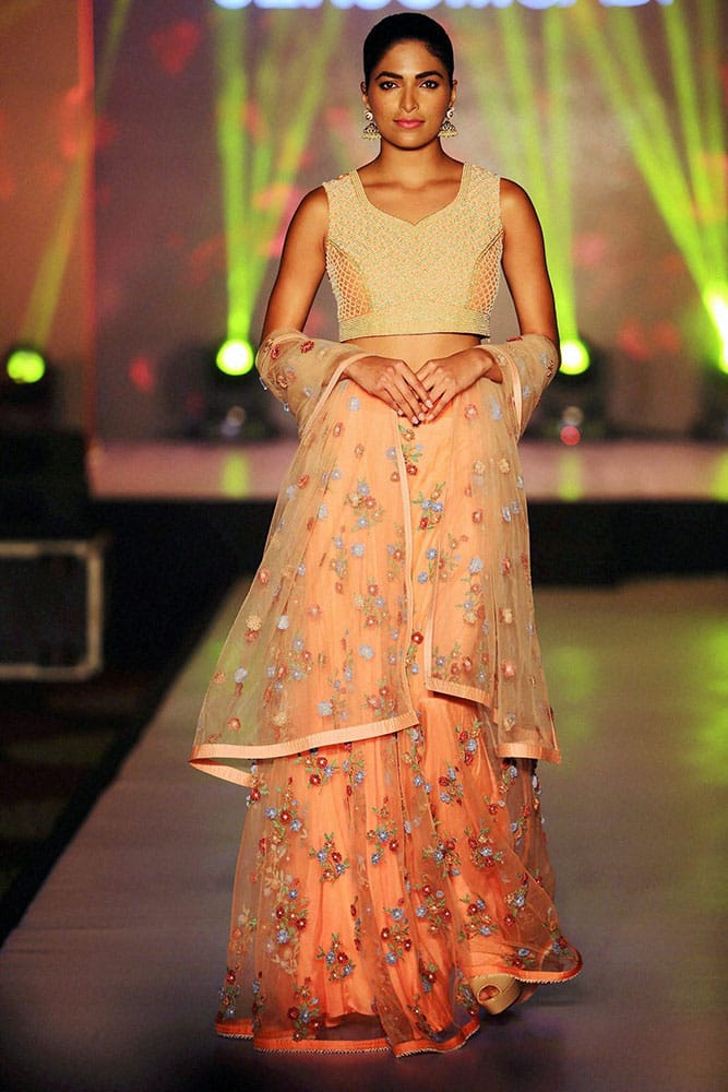 Actress and former Miss India Parvathy Omanakuttan walks the ramp during a fashion show.