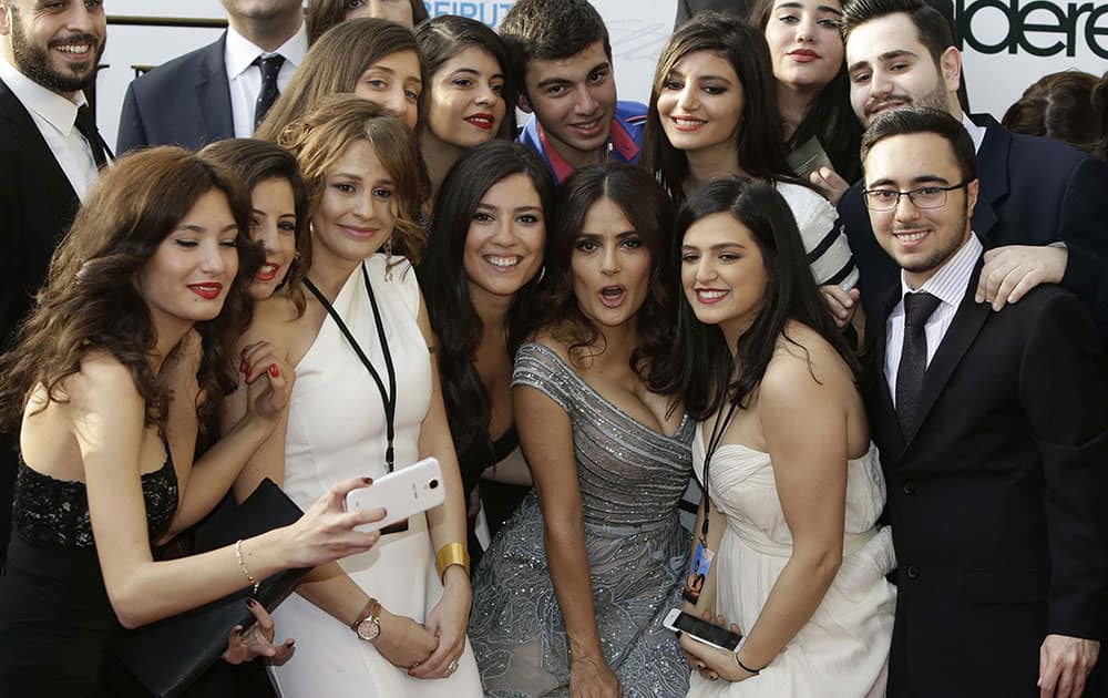 Mexican and American actress Salma Hayek poses for photographers with fans as she arrives to her international premiere film The Prophet, an animated feature film she co-produced, in Beirut, Lebanon.