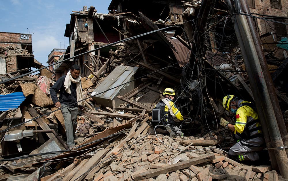 Members of the Chinese rescue team search in debris of collapsed houses after Saturday's earthquake in Bhaktapur, Nepal.
