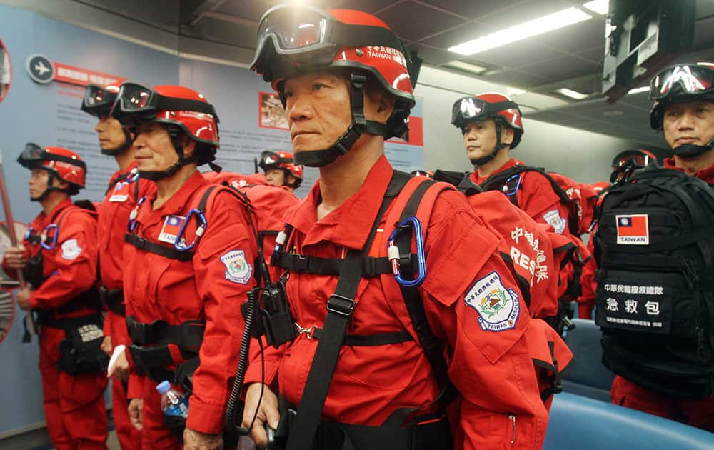 Taiwan's emergency search and rescue team members stand for inspection before heading to Nepal to assist with the earthquake relief effort at the Taoyuan International Airport in Taoyuan, Taiwan.