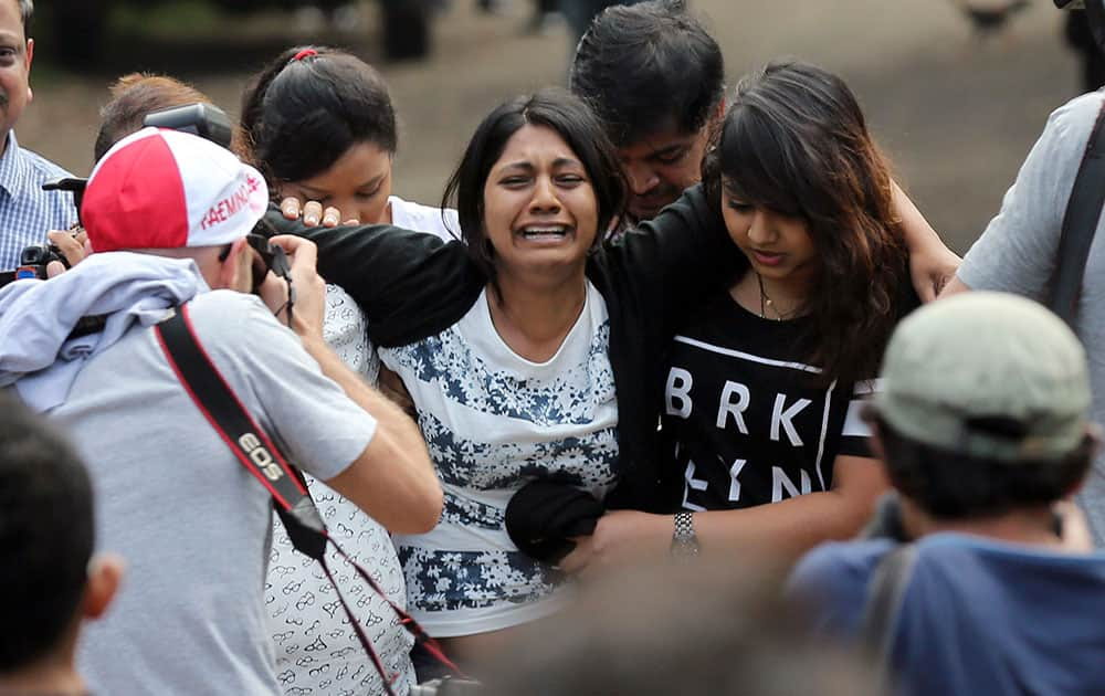 Brintha Sukumaran, center, sisters of Myuran Sukumaran, an Australian on death row, cries upon arrival at Wijayapura ferry port to cross to the prison island of Nusakambangan, in Cilacap, Central Java, Indonesia.