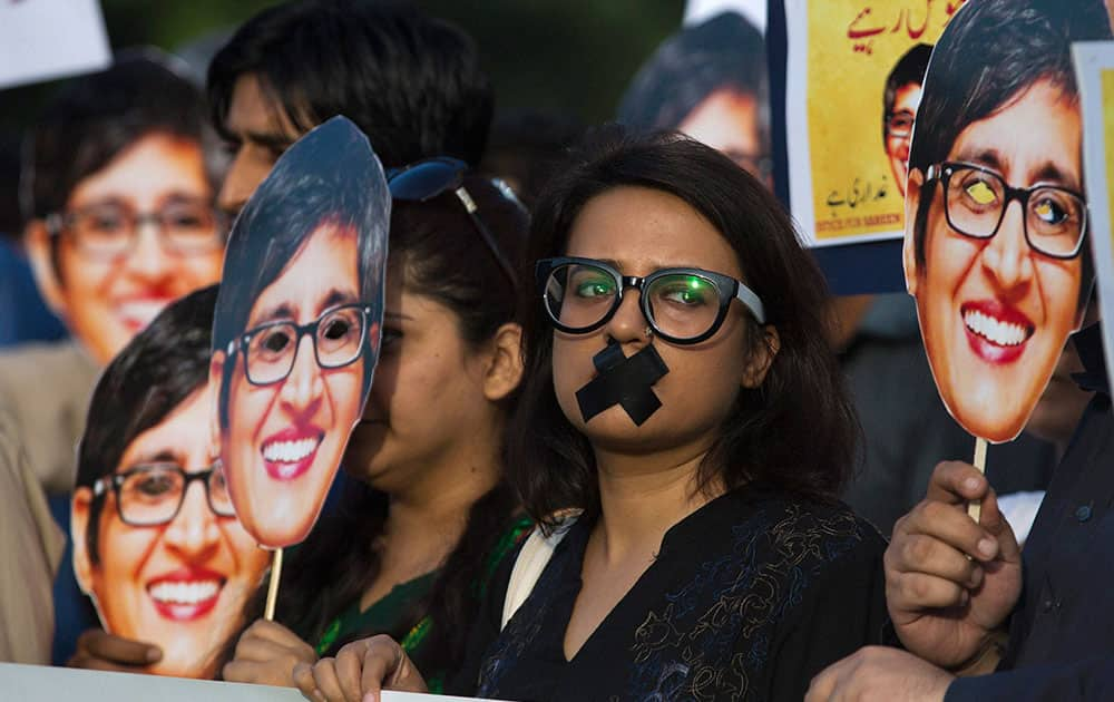 Supporters of prominent womens rights activist Sabeen Mahmud, who was killed by unknown gunmen, hold her pictures during a rally, in Islamabad, Pakistan.