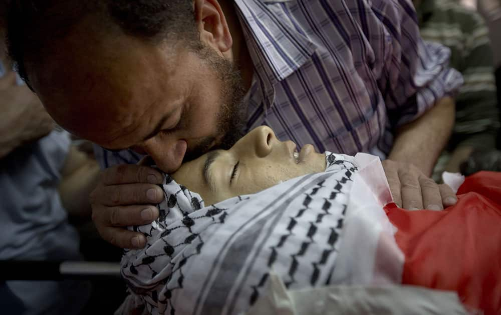 A Palestinian man kisses the forehead of Mohammed Yehya, who died from wounds in clashes with Israeli troops the night before, during his funeral procession, in the al-Araqa village in the west bank city of Jenin.