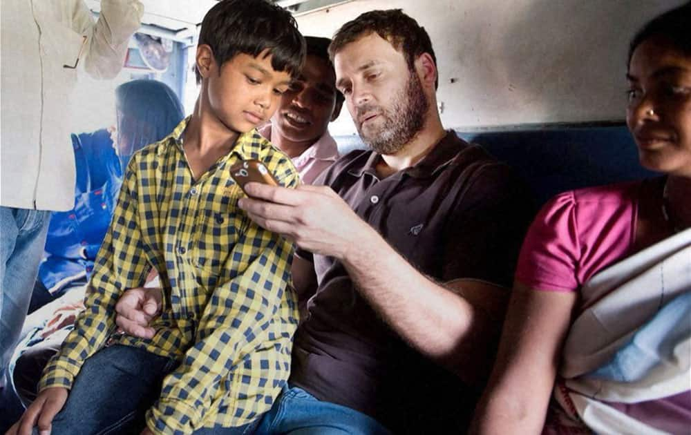 Congress VP Rahul Gandhi interacts with passengers on-board Sachkhand Express on his way to Punjab to take stock of farmers situation who have suffered due to unseasonal rainfall, in New Delhi.