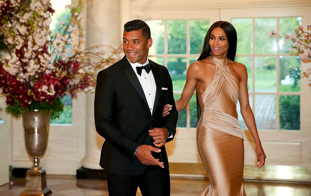 Seattle Seahawks Quarterback Russell Wilson and entertainer Ciara Harris arrive for a state dinner for Japanese Prime Minister Shinzo Abe, at the White House in Washington.