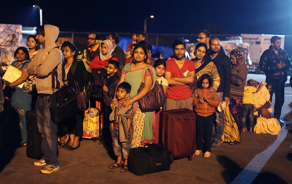 Survivors of Saturday's earthquake wait to board a military plane evacuating injured and stranded Indians from Kathmandu to New Delhi.