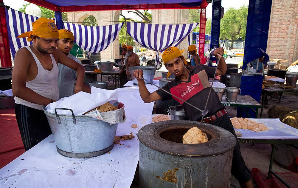 Workers prepare rotis, a type of Indian bread at the Bangla Sahib Sikh temple to be shipped as relief material to Nepal in New Delhi.