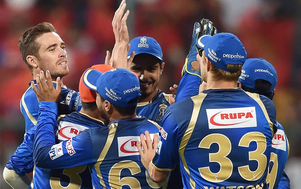 Rajasthan Royals Tim Southee celebrates with team mates the wicket of Chris Gayle during IPL 8 match against Royal Challengers Bangalore in Bengaluru.