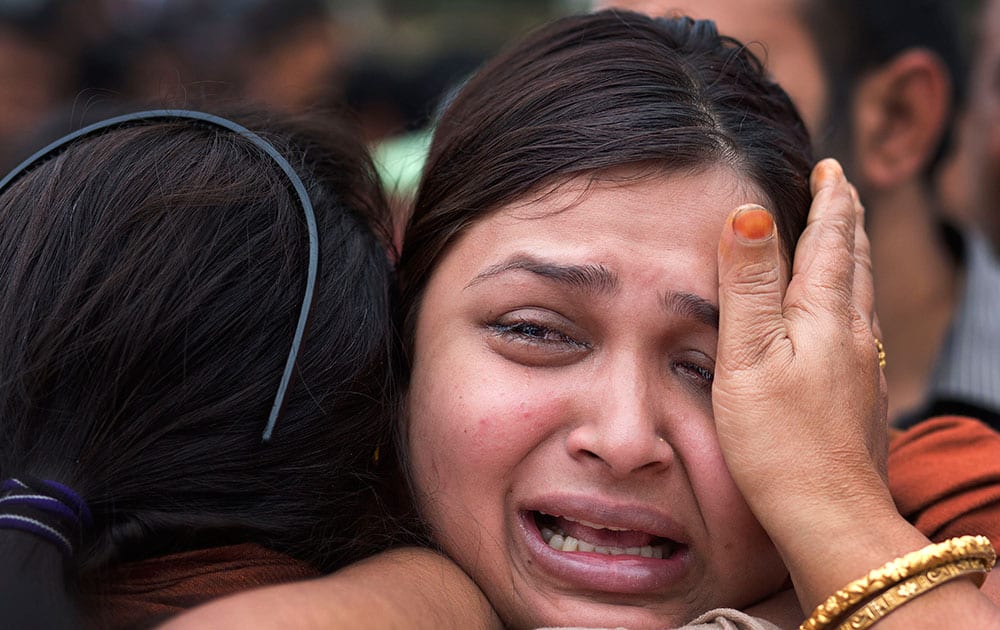 A girl cries near the coffin of her mother Hema Prabha Saikia, a victim of Saturday’s earthquake in Nepal, in Gauhati.