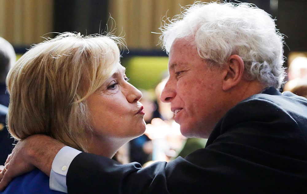 Hillary Rodham Clinton, a 2016 Democratic presidential contender, and Mark Green, a former New York mayoral candidate, exchange a kiss following her speech at the David N. Dinkins Leadership and Public Policy Forum,  in New York.
