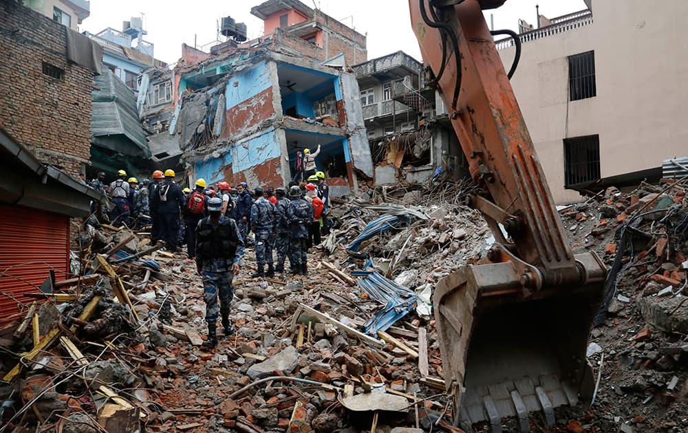 Nepal policemen cordon off the area as they and US rescue workers prepare to pull out Pemba Tamang, a teenage boy from the rubble of a building five days after the earthquake in Kathmandu