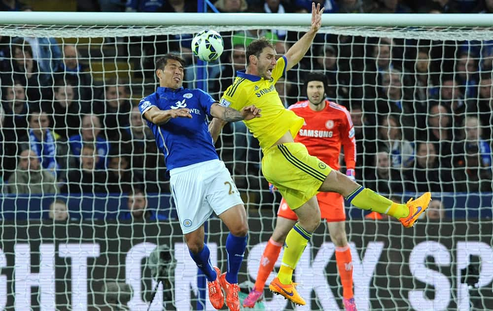 Leicester's Leonardo Ulloa, left, contest the ball with Chelsea's Branislav Ivanovic during the English Premier League soccer match between Leicester City and Chelsea at the King Power Stadium, Leicester, England.