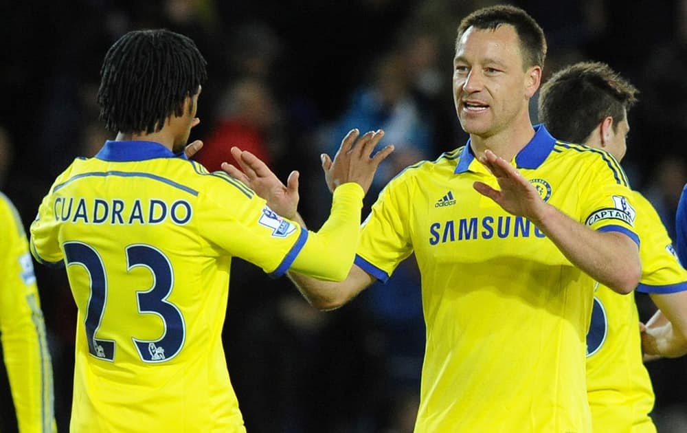 Chelsea's John Terry celebrates with Juan Cuadrado after beating Leicester 3-1 during the English Premier League soccer match at the King Power Stadium, Leicester, England.