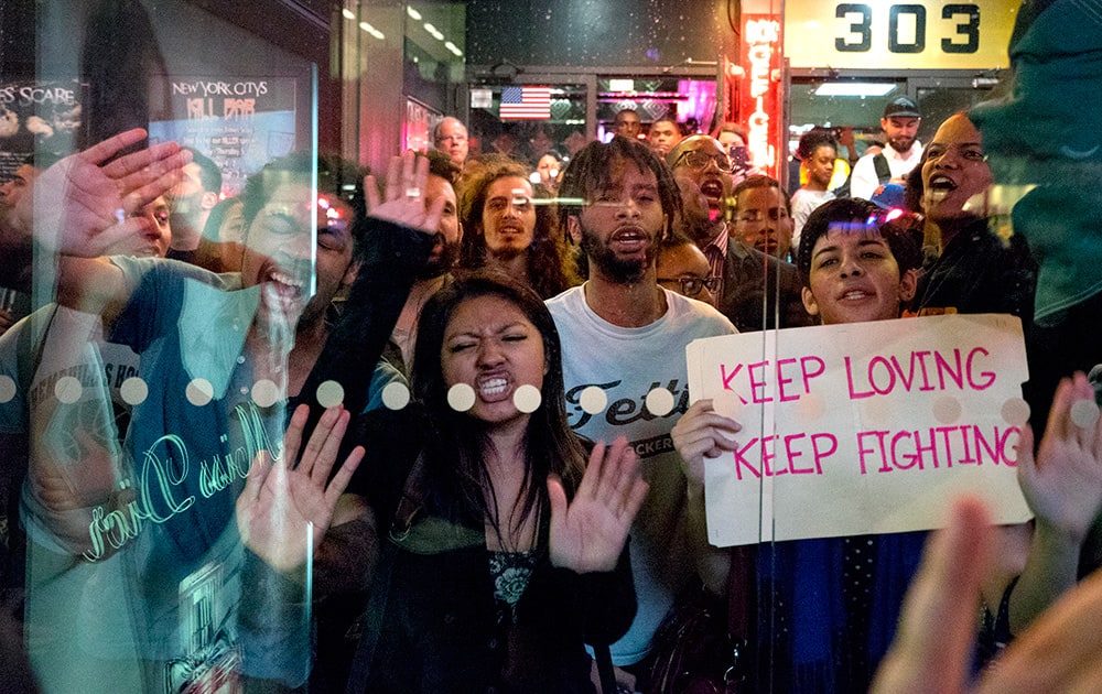 Protesters slam their hands against a bus shelter as they chant, in New York. People gathered to protest the death of Freddie Gray, a Baltimore man who was critically injured in police custody.