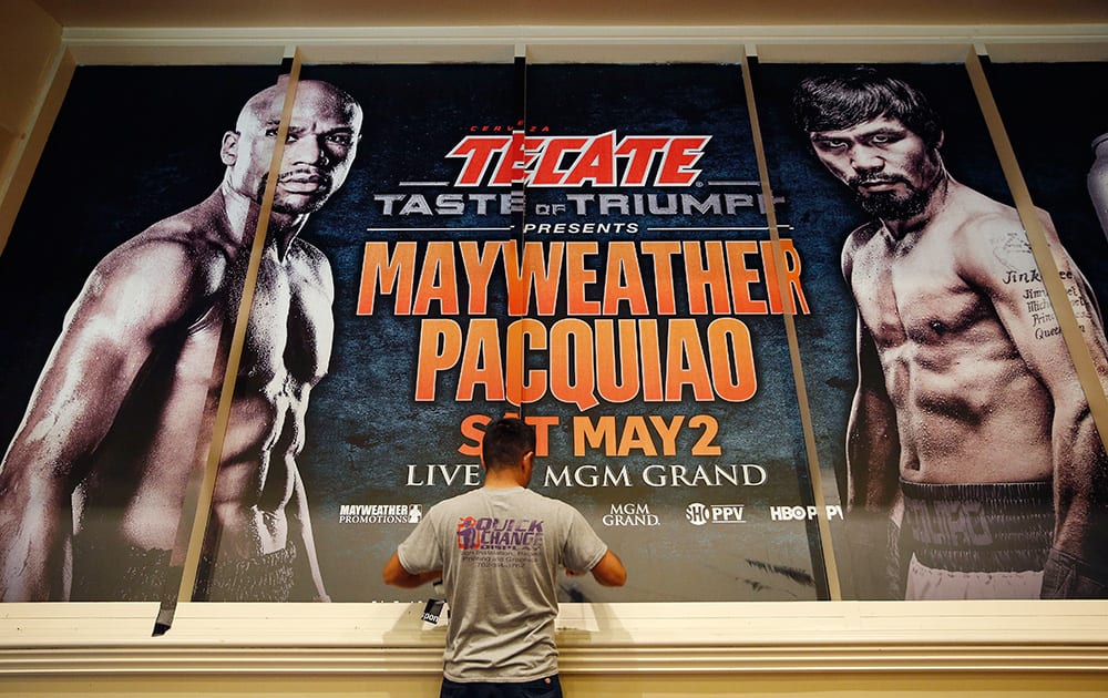 Jose Arroyo installs an advertisement for a fight between Floyd Mayweather Jr. and Manny Pacquiao at the MGM Grand, in Las Vegas. The fight is scheduled to take place May 2 at the hotel and casino.