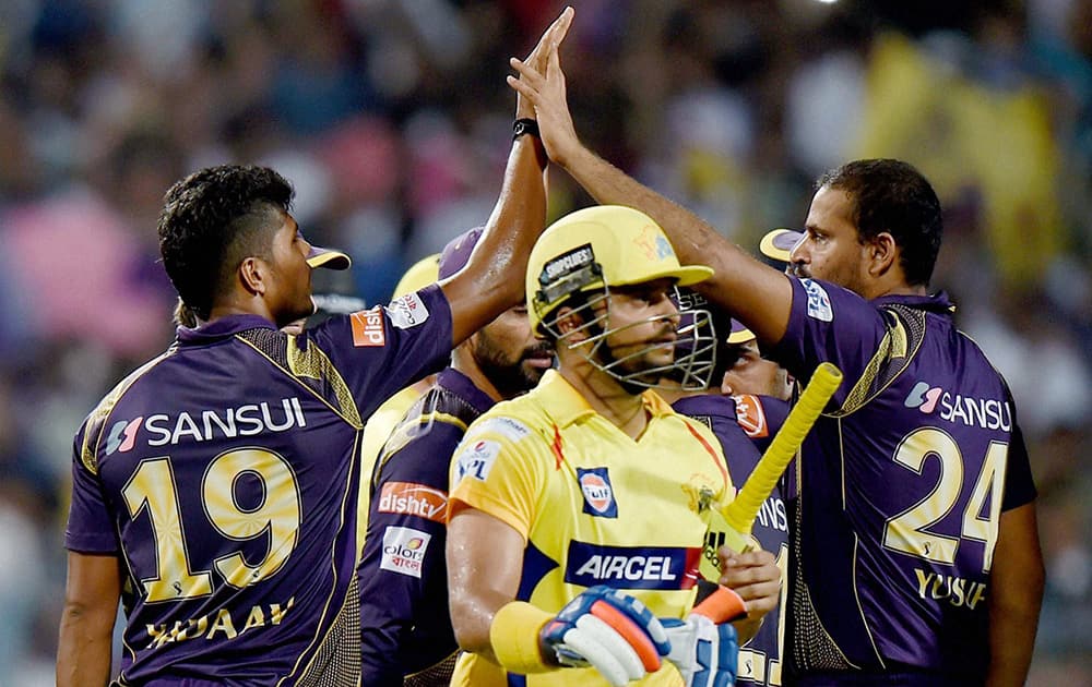 KKR bowler Umesh Yadav celebrates with teammates after dismissing Chennai Super Kings batsman Suresh Raina during IPL Match at Eden Garden in Kolkata.