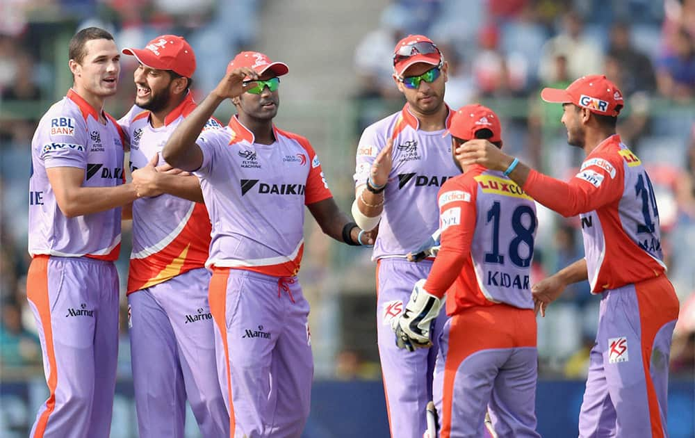 Delhi Daredevils bowler N Coulter-Nile celebrates with his teammates after he takes wicket of Kings XI Punjab batsman WP Saha during an IPL match, New Delhi.