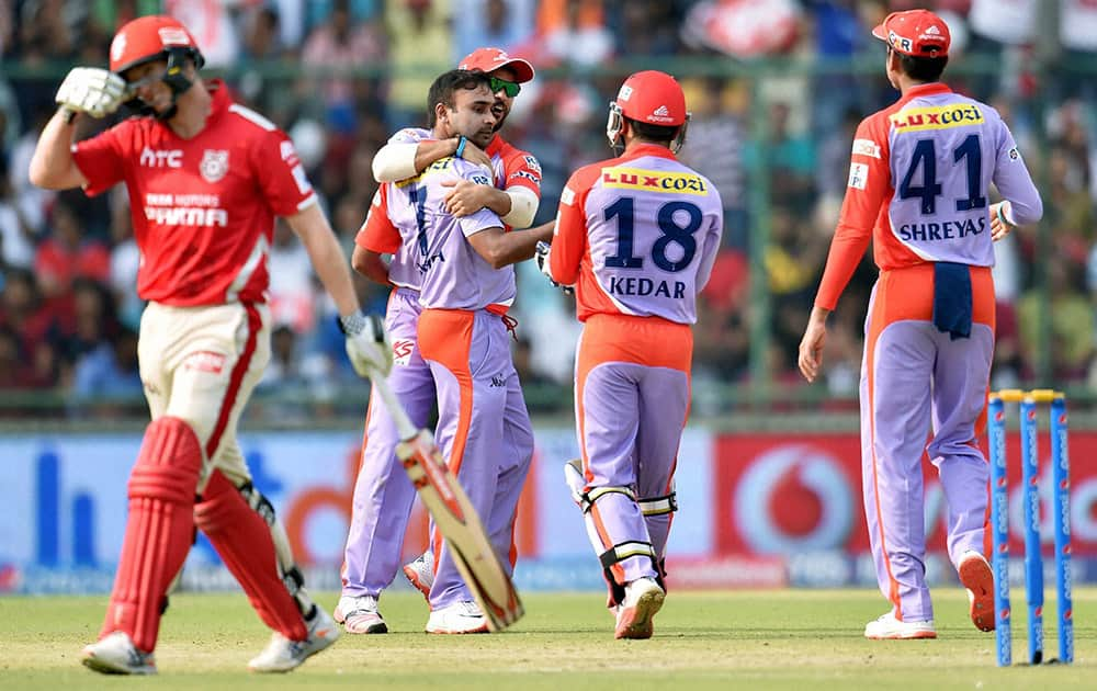 Delhi Daredevils bowler Amit Mishra celebrate with team mates after taking wicket of Kings XI Punjabs captain George Bailey (L) during an IPL match in New Delhi.