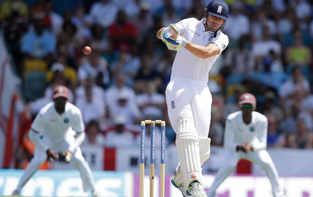 England captain Alistair Cook plays a shot from the bowling of West Indies' Jerome Taylor during day one of their third Test match at the Kensington Oval in Bridgetown, Barbados.