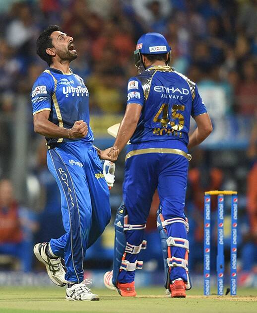 Rajasthan Royals bowler Dhawal Kulkarni celebrates the wicket of Mumbai Indians batsman Rohit Sharma during an IPL match in Mumbai.