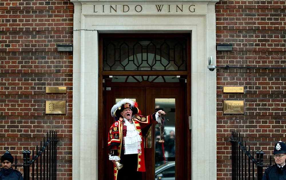 Tony Appleton, a town crier, announces to the assembled media the birth of the royal baby, outside the Lindo Wing, St. Mary's Hospital, London. Kate, the Duchess of Cambridge, has given birth to a baby girl, royal officials said Saturday.