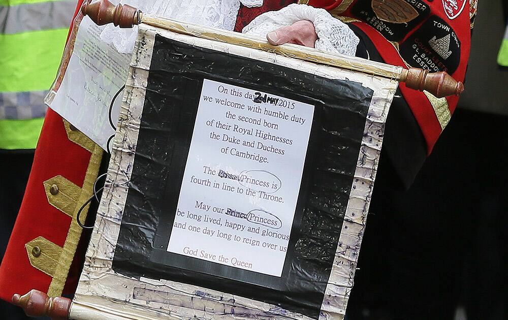 Tony Appleton, a town crier, announces to the assembled media the birth of the royal baby, outside the Lindo Wing, St. Mary's Hospital, London. Kate, the Duchess of Cambridge, has given birth to a baby girl, royal officials said Saturday. 