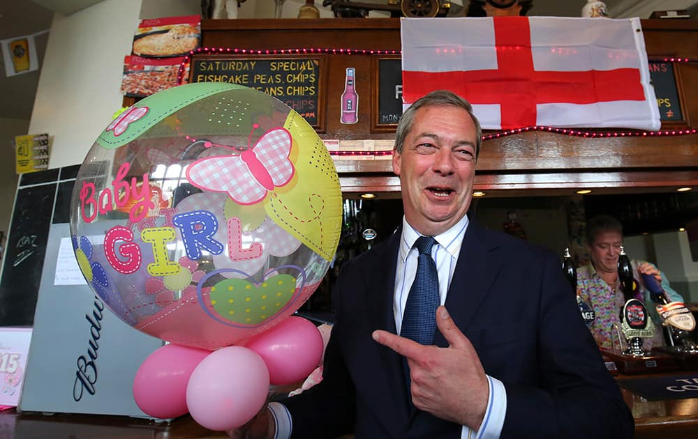 Britain's United Kingdom Independence Party (UKIP) leader Nigel Farage celebrates the birth of the Royal baby at a public house in Ramsgate, Kent, during a day of campaigning for the the upcoming general election.